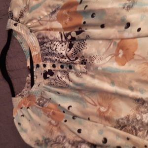 TURQUOISE,BLACK BEIGE AND WHITE blouse with 3 sm. buttons on the front neckline.